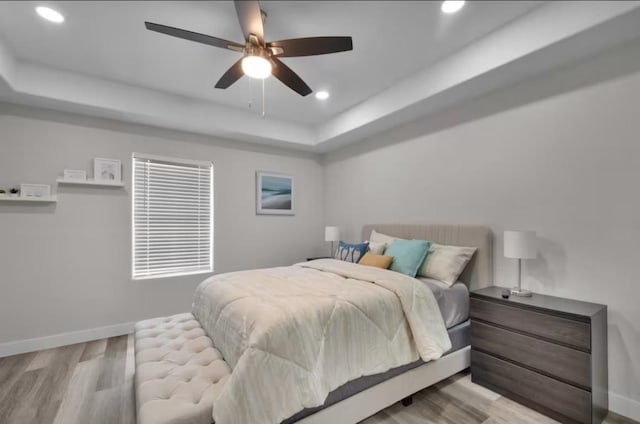 102 W Corral St Unit 2, South Padre Island, TX 78597 - bedroom featuring baseboards, light wood finished floors, a tray ceiling, and recessed lighting