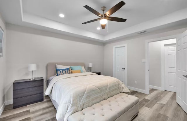 102 W Corral St Unit 2, South Padre Island, TX 78597 - bedroom featuring a tray ceiling, recessed lighting, baseboards, light wood finished floors, and visible vents