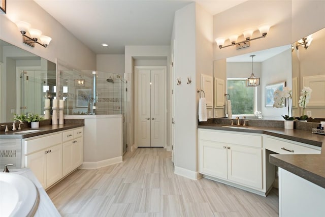 1300 Morning Moon Cir, Austin, TX 78732 - full bathroom with a stall shower, two vanities, a bath, and recessed lighting