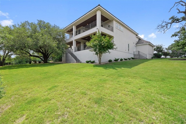 1300 Morning Moon Cir, Austin, TX 78732 - view of side of home with stairway, a lawn, and stucco siding