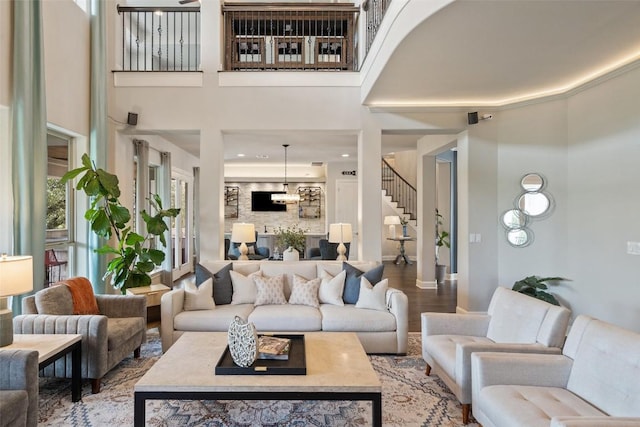 1300 Morning Moon Cir, Austin, TX 78732 - living area featuring a towering ceiling, stairway, and wood finished floors