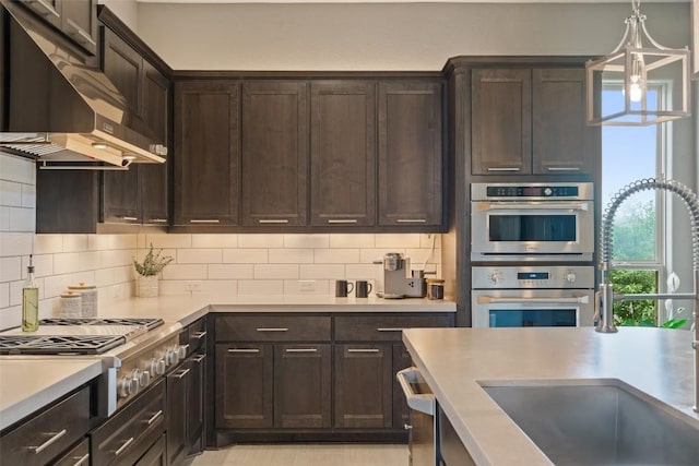 1300 Morning Moon Cir, Austin, TX 78732 - kitchen featuring range hood, appliances with stainless steel finishes, a sink, dark brown cabinetry, and light countertops