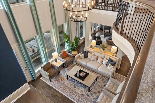 1300 Morning Moon Cir, Austin, TX 78732 - living room with a chandelier, wood finished floors, baseboards, stairs, and a towering ceiling