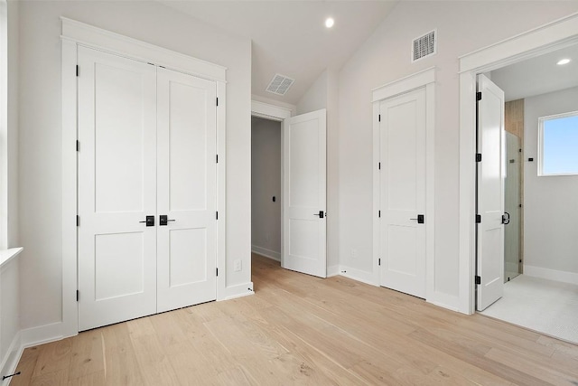 6309 Friendswood Dr, Austin, TX 78723 - unfurnished bedroom with light wood finished floors, lofted ceiling, recessed lighting, and connected bathroom
