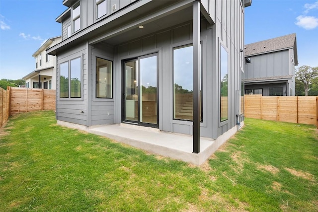 6309 Friendswood Dr, Austin, TX 78723 - back of house with board and batten siding and a fenced backyard