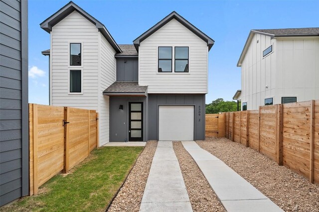 6309 Friendswood Dr, Austin, TX 78723 - contemporary home with roof with shingles, board and batten siding, an attached garage, and a fenced backyard