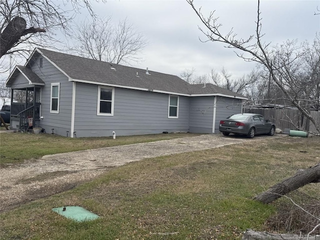 211 Murphy St, Taylor, TX 76574 - view of side of home featuring a lawn, roof with shingles, and crawl space