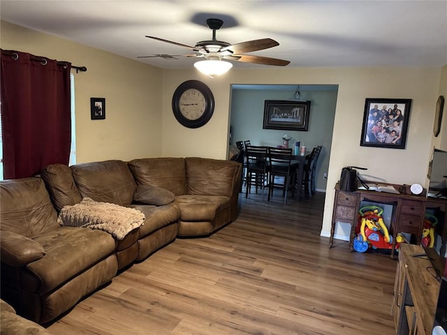 211 Murphy St, Taylor, TX 76574 - living room featuring a ceiling fan, light wood-style floors, and baseboards