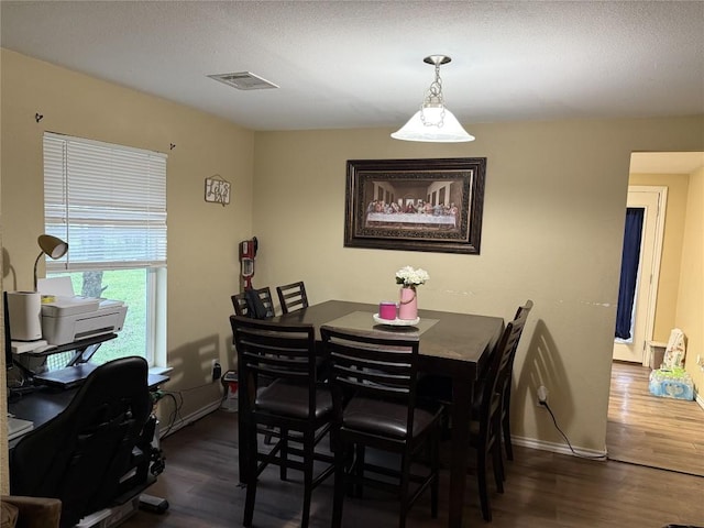 211 Murphy St, Taylor, TX 76574 - dining space featuring dark wood-type flooring and baseboards