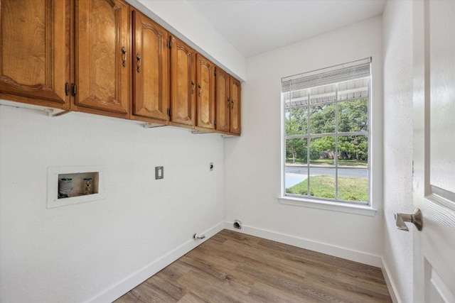laundry room with wood finished floors, electric dryer hookup, cabinet space, hookup for a washing machine, and baseboards