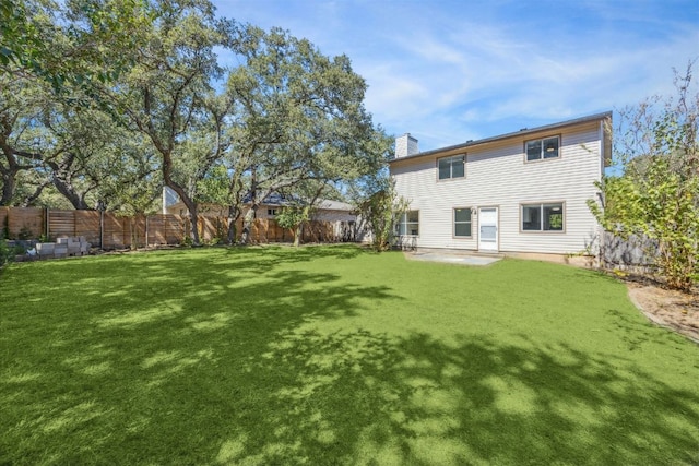 4525 Langtry Ln, Austin, TX 78749 - back of property featuring a fenced backyard, a chimney, and a patio