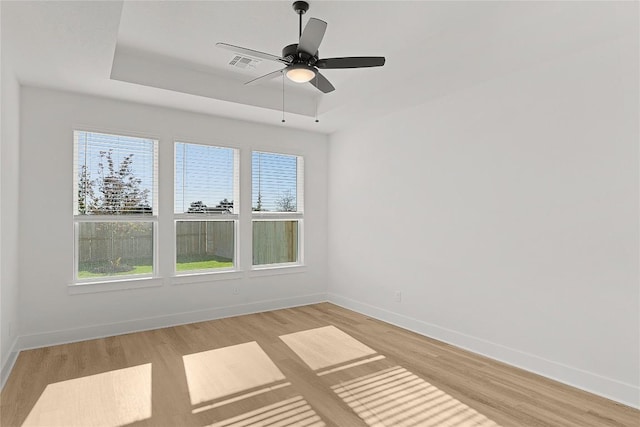 505 Golden Sage Ave, Georgetown, TX 78633 - spare room with a tray ceiling, light wood-style floors, and a ceiling fan
