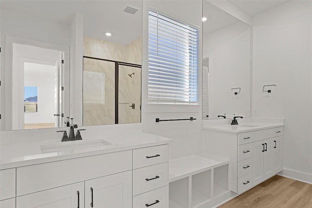 505 Golden Sage Ave, Georgetown, TX 78633 - full bath with a marble finish shower, two vanities, and wood finished floors