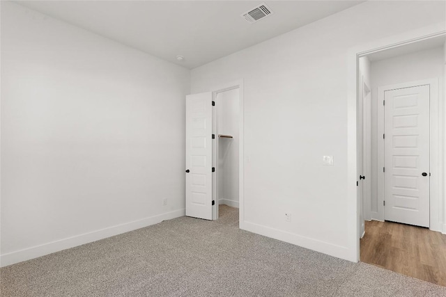 505 Golden Sage Ave, Georgetown, TX 78633 - unfurnished bedroom featuring light colored carpet and a walk in closet