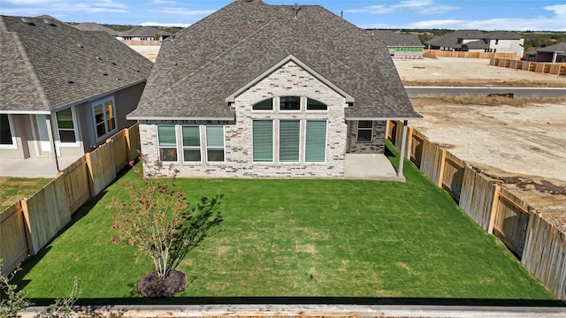 505 Golden Sage Ave, Georgetown, TX 78633 - rear view of house with brick siding, a fenced backyard, a shingled roof, and a residential view