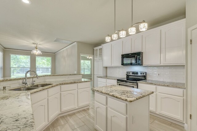 kitchen with stainless steel electric stove, black microwave, a sink, backsplash, and white cabinets