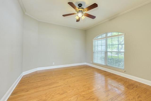 empty room featuring light wood-type flooring, ceiling fan, ornamental molding, and baseboards
