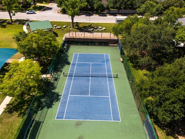 view of tennis court featuring fence