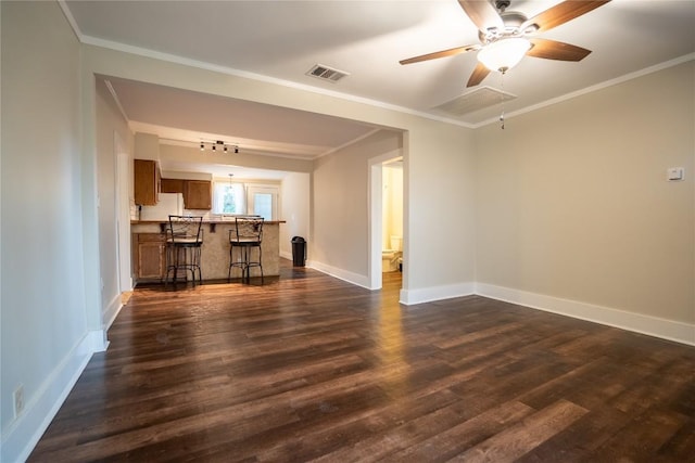 unfurnished living room with ornamental molding, dark wood-type flooring, baseboards, and ceiling fan