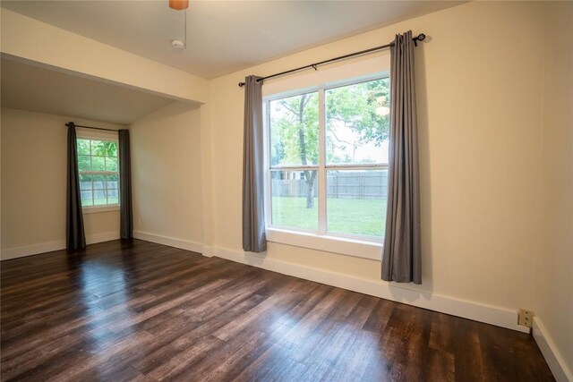 103 S Cornelius St, Thorndale, TX 76577 - unfurnished room featuring dark wood-style flooring, plenty of natural light, and baseboards