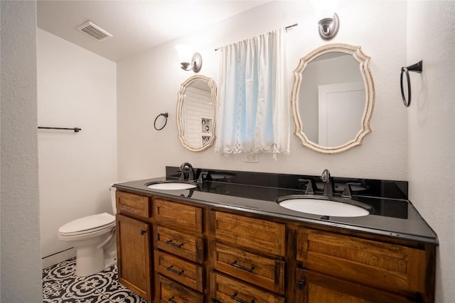 full bathroom featuring a sink, double vanity, toilet, and visible vents