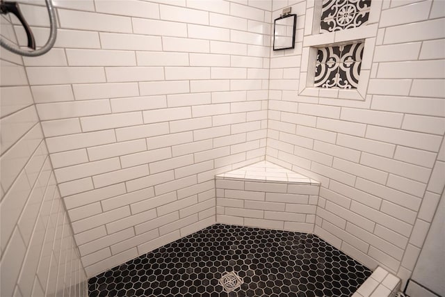 full bath with a tile shower