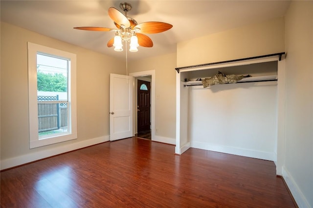 unfurnished bedroom featuring baseboards, a ceiling fan, and wood finished floors