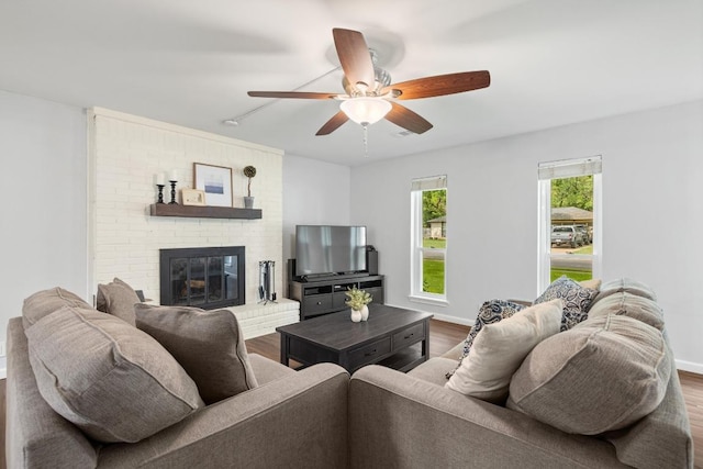 105 S Rainbow Bridge Dr, Cedar Park, TX 78613 - living area with wood finished floors, a ceiling fan, and a fireplace