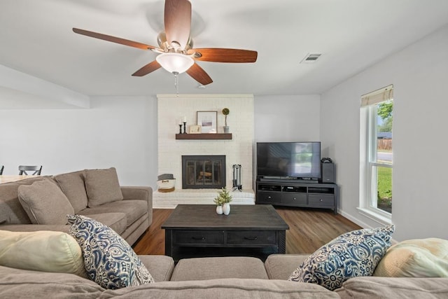 105 S Rainbow Bridge Dr, Cedar Park, TX 78613 - living room with dark wood-style floors, ceiling fan, and a brick fireplace