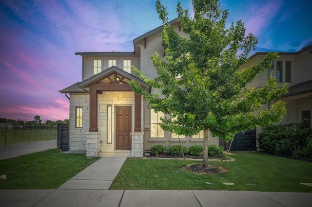 6800 Idea Rd, Austin, TX 78741 - view of front of house featuring fence, a front lawn, and stone siding