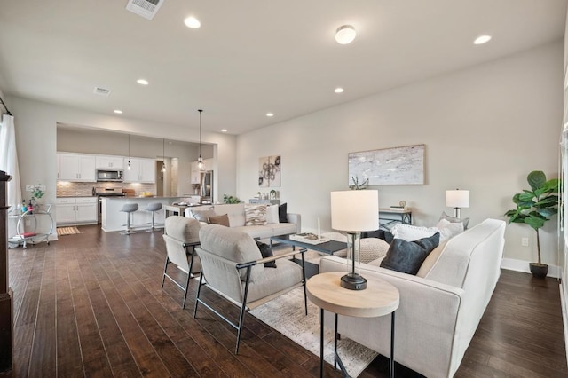 6800 Idea Rd, Austin, TX 78741 - living area featuring dark wood-style flooring, recessed lighting, and visible vents