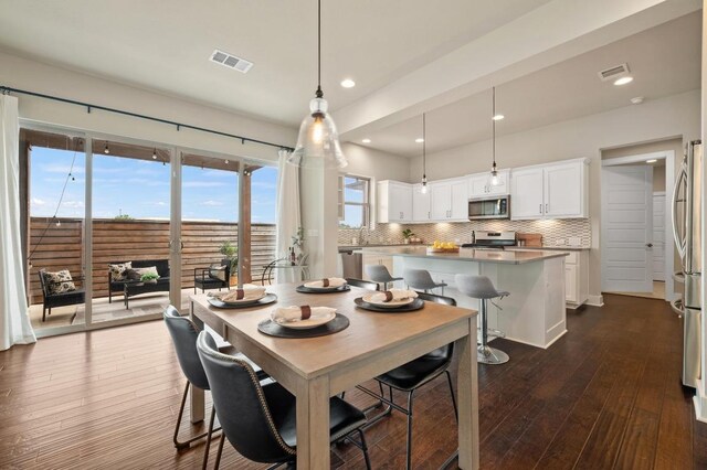 6800 Idea Rd, Austin, TX 78741 - dining room with recessed lighting, dark wood finished floors, visible vents, and plenty of natural light