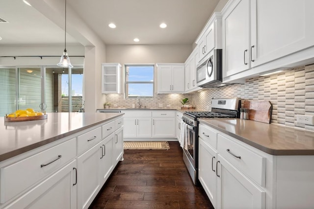 6800 Idea Rd, Austin, TX 78741 - kitchen with a sink, stainless steel appliances, dark wood-type flooring, recessed lighting, and decorative backsplash