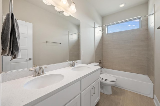 6800 Idea Rd, Austin, TX 78741 - full bathroom featuring double vanity, toilet, bathing tub / shower combination, and a sink