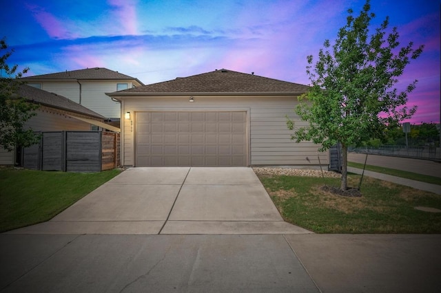 6800 Idea Rd, Austin, TX 78741 - single story home with concrete driveway, a garage, fence, and a lawn
