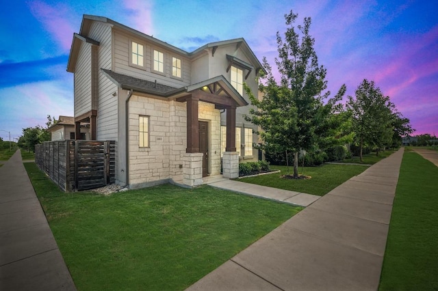 6800 Idea Rd, Austin, TX 78741 - view of front of property featuring a yard, fence, and stone siding