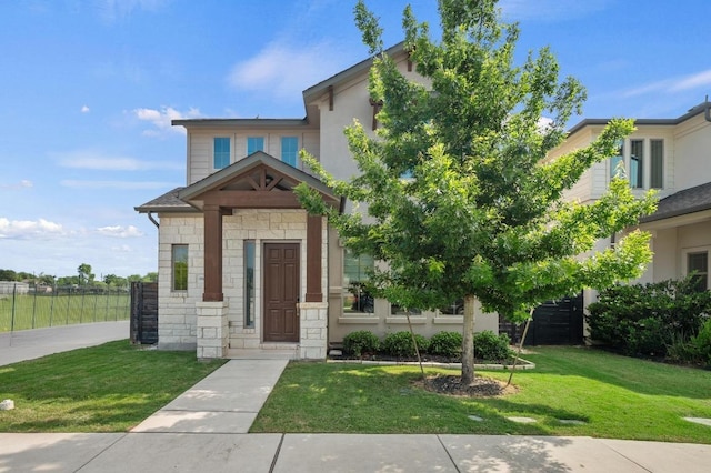 6800 Idea Rd, Austin, TX 78741 - view of front of property featuring stone siding, fence, and a front lawn