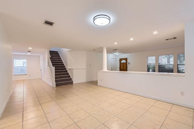 1171 Southern Pl, Round Rock, TX 78665 - unfurnished living room featuring stairs, recessed lighting, light tile patterned floors, and ornate columns