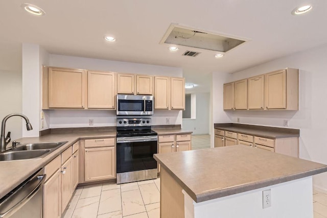 1171 Southern Pl, Round Rock, TX 78665 - kitchen featuring light brown cabinetry, appliances with stainless steel finishes, recessed lighting, a center island, and dark countertops