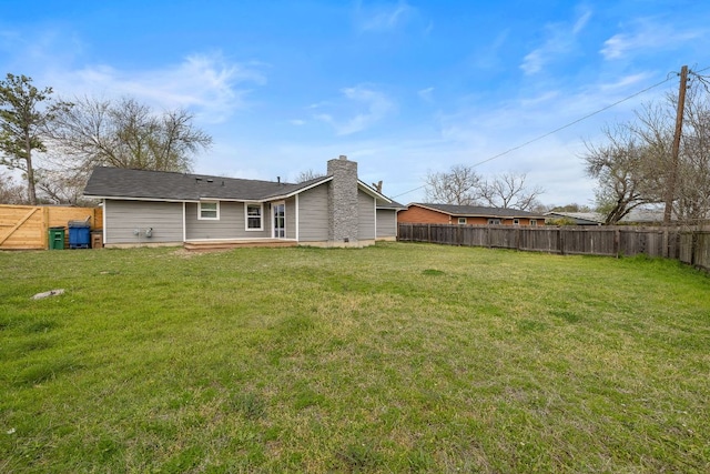 2927 Norwood Hill Rd, Austin, TX 78723 - rear view of house featuring a fenced backyard and a chimney