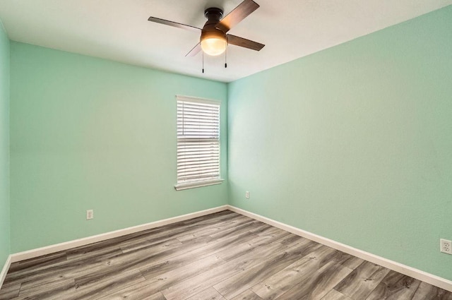 305 Bird Dog Bnd, Bastrop, TX 78602 - spare room featuring wood finished floors, baseboards, and a ceiling fan