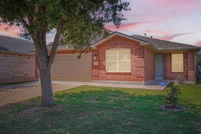 single story home featuring concrete driveway, a front yard, brick siding, and an attached garage