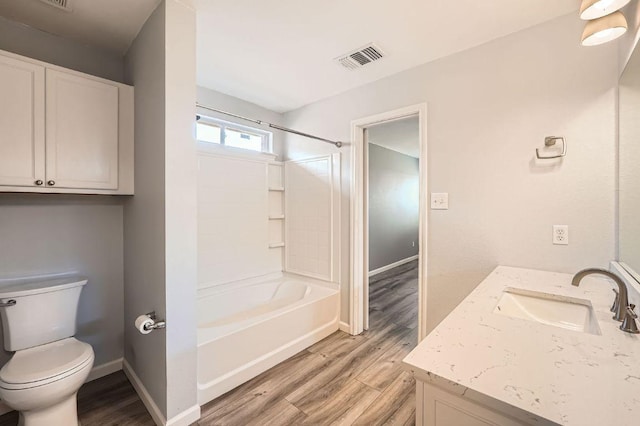 305 Bird Dog Bnd, Bastrop, TX 78602 - full bathroom featuring wood finished floors, vanity, toilet, and bathing tub / shower combination
