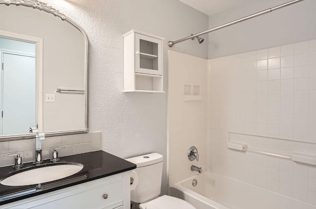 305 Bird Dog Bnd, Bastrop, TX 78602 - full bath with a textured wall, toilet, vanity, and bathing tub / shower combination