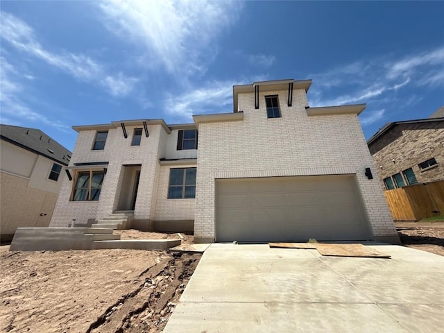 1033 Blanket Flower Dr, Georgetown, TX 78628 - prairie-style house featuring fence, an attached garage, concrete driveway, and brick siding