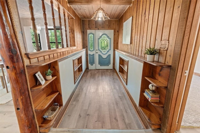 entryway with wooden ceiling, wood walls, and wood finished floors