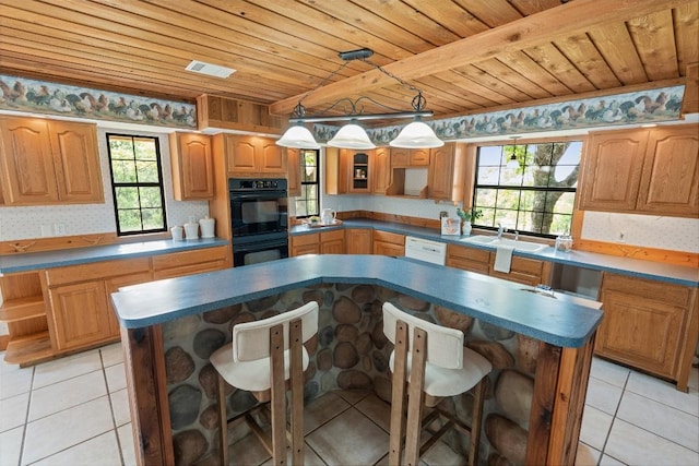 kitchen with a center island, wooden ceiling, visible vents, a sink, and dobule oven black
