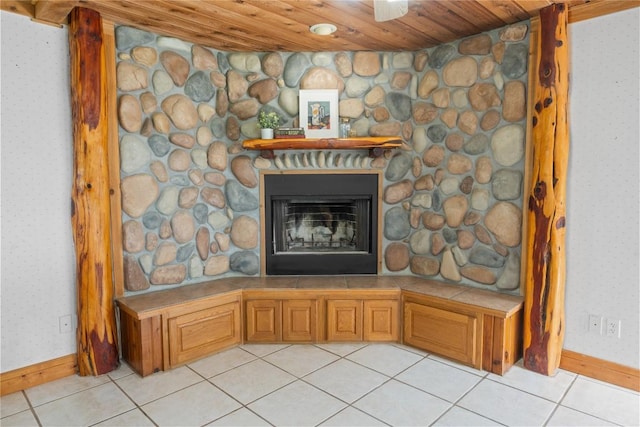 room details featuring wallpapered walls, wooden ceiling, a fireplace, and baseboards