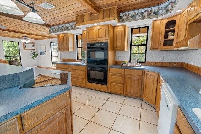 kitchen featuring a wealth of natural light, wood ceiling, dobule oven black, and white dishwasher
