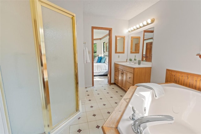 full bathroom with a shower stall, ensuite bath, vanity, and a bath